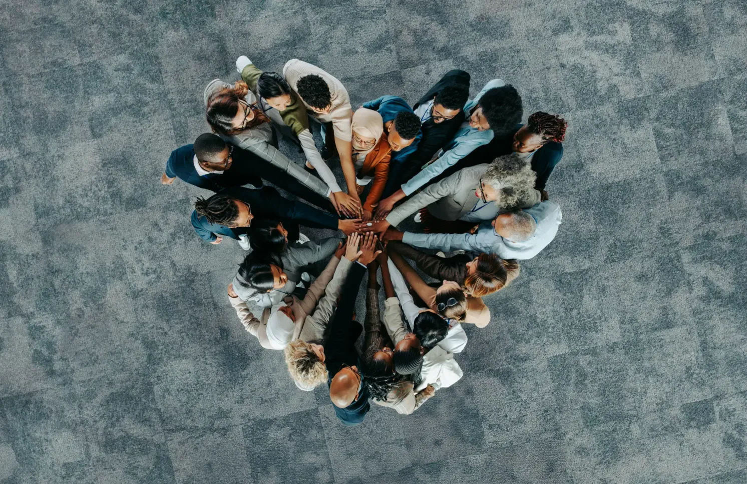 A diverse business group standing in a heart formation, symbolizing unity, teamwork, and collaboration.