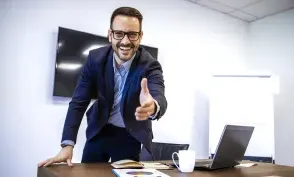 Portrait of businessman in elegant suit showing welcoming hand to the new employees.